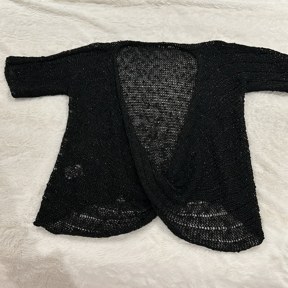 Black iridescent crocheted short sleeve sweater with cross over detail.